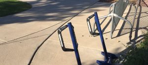 an empty bike rack on a concrete sidewalk