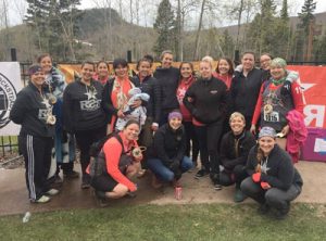 Group of about 20 women runners posing for photo